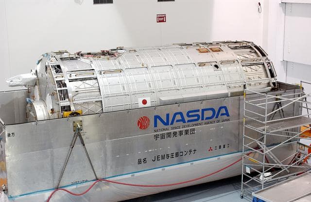 NASA image: KENNEDY SPACE CENTER, FLA. -  In the Space Station Processing Facility, the Japanese Experiment Module (JEM) pressure module is exposed after removal of the lid of its shipping container.  A research laboratory, the pressurized module is the first element of the JEM, named "Kibo" (Hope), to be delivered to KSC.   The National Space Development Agency of Japan (NASDA) developed the laboratory at the Tsukuba Space Center near Tokyo and is Japan's primary contribution to the Station. It will enhance the unique research capabilities of the orbiting complex by providing an additional environment for astronauts to conduct science experiments.  The JEM also includes an exposed facility (platform) for space environment experiments, a robotic manipulator system, and two logistics modules. The various JEM components will be  assembled in space over the course of three Shuttle missions.