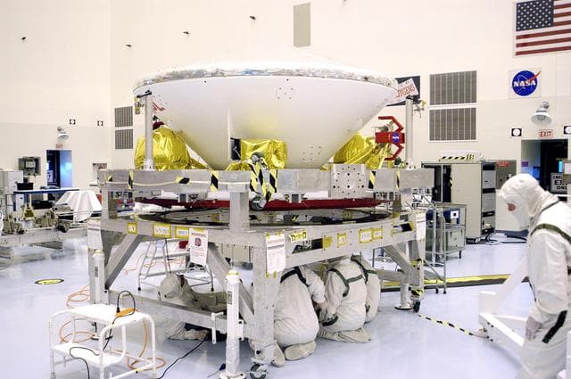 NASA image: KENNEDY SPACE CENTER, FLA. - Workers in the Payload Hazardous Servicing Facility prepare Mars Exploration Rover 1 (MER-B) to be mated with the third stage of the Delta rocket that will launch it to Mars.  The second of twin rovers being sent to Mars, it is equipped with a robotic arm, a drilling tool, three spectrometers, and four pairs of cameras that allow it to have a human-like, 3D view of the terrain. Each rover could travel as far as 100 meters in one day to act as Mars scientists' eyes and hands, exploring an environment where humans can't yet go.  MER-B is scheduled to launch from Launch Pad 17-B, Cape Canaveral Air Force Station, June 26 at one of two available times,  12:27:31 a.m. EDT or 1:08:45 a.m. EDT.