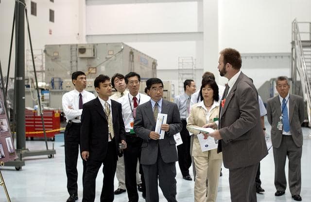 NASA image: KENNEDY SPACE CENTER, FLA. -  In the Space Station Processing Facility, Executive Director of NASDA Koji Yamamoto (center) joins others for a tour.  Mr. Yamamoto is at KSC for a welcome ceremony involving the arrival of the newest Space Station module, the Japanese Experiment Module/pressurized module.