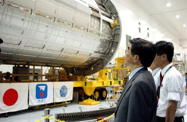 NASA image: KENNEDY SPACE CENTER, FLA. -  In the Space Station Processing Facility, Executive Director of NASDA Koji Yamamoto (left) looks at the newly arrived Japanese Experiment Module (JEM)/pressurized module.  Mr. Yamamoto is at KSC for a welcome ceremony involving the arrival of JEM.