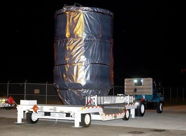 NASA image: KENNEDY SPACE CENTER, FLA. -  The Mars Exploration Rover 1 (MER-B) is moved  out of the Payload Hazardous Servicing Facility for transfer to Launch Pad 17-B, Cape Canaveral Air Force Station.  The second of twin rovers being sent to Mars, it is equipped with a robotic arm, a drilling tool, three spectrometers, and four pairs of cameras that allow it to have a human-like, 3D view of the terrain. Each rover could travel as far as 100 meters in one day to act as Mars scientists' eyes and hands, exploring an environment where humans can't yet go.  MER-B is scheduled to launch June 26 at one of two available times,  12:27:31 a.m. EDT or 1:08:45 a.m. EDT.