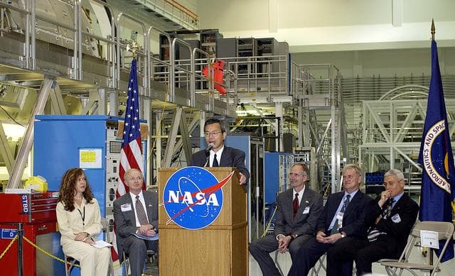 NASA image: KENNEDY SPACE CENTER, FLA. -  Kuniaki Shiraki, JEM Project manager, National Aerospace and Development Agency of Japan,  speaks to guests and the media gathered in the Space Station Processing Facility at a ceremony highlighting the arrival of two major components of the International Space Station.  NASA's Node 2, built by the European Space Agency (ESA) in Italy, arrived at KSC on June 1. It will be the next pressurized module installed on the Station. The pressurized module of the Japanese Experiment Module (JEM), named "Kibo" (Hope), arrived at KSC on June 4. It is Japan's primary contribution to the Station. The ceremony held today included the official transfer of ownership signing of Node 2 between the ESA and NASA.. Emceed by Lisa Malone (far left), deputy director of External Relations and Business Development at KSC, the ceremony also included these speakers: Center Director Roy Bridges Jr. (second from left); NASA’s Michael C. Kostelnik, deputy associate administrator for International Space Station and Shuttle Programs and William Gerstenmaier, International Space Station Program manager; Alan Thirkettle, International Space Station Program manager for Node 2, ESA; and Andrea Lorenzoni, International Space Station Program manager for Node 2, Italian Space Agency.