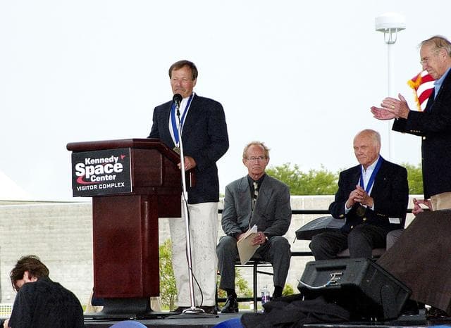 NASA image: KENNEDY SPACE CENTER, FLA. -  At the KSC Visitor Complex, former astronaut Robert "Hoot" Gibson (at podium) addresses the audience at his induction ceremony into the U.S. Astronaut Hall of Fame. Also standing is former astronaut James A. Lovell.  Seated on the dais, from left, are actor and Master of Ceremonies Lance Henriksen and former astronaut John H. Glenn.  Also being inducted with Gibson are Space Shuttle astronauts Daniel Brandenstein, Story Musgrave, and Sally K. Ride. Conceived by six of the Mercury Program astronauts, the U.S. Astronaut Hall of Fame opened in 1990 to provide a place where space travelers could be remembered for their participation and accomplishments in the U.S. space program. The four new inductees join 48 previously honored astronauts from the ranks of the Gemini, Apollo, Skylab, Apollo-Soyuz, and Space Shuttle programs.