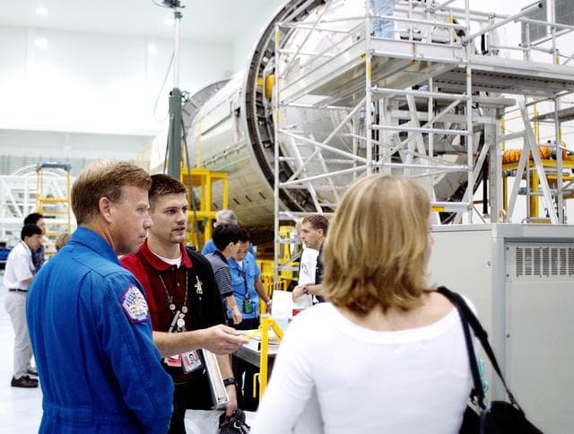 NASA image: KENNEDY SPACE CENTER, FLA. -  NASA astronaut Steven W. Lindsey (left) listens to a briefing about the pressurized module of the Japanese Experiment Module (JEM) in the Space Station Processing Facility.  This major component of JEM, named "Kibo" (Hope), is Japan's primary contribution to the International Space Station and arrived at KSC on June 4.  Lindsey is assigned to command STS-119, an upcoming Space Shuttle flight to the Station.