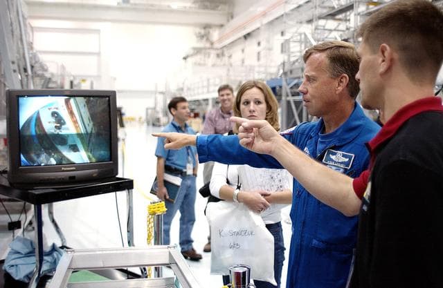 NASA image: KENNEDY SPACE CENTER, FLA. -  NASA astronaut Steven W. Lindsey (second from right) views the interior of the pressurized module of the Japanese Experiment Module (JEM) on a television monitor in the Space Station Processing Facility.  This major component of JEM, named "Kibo" (Hope), is Japan's primary contribution to the International Space Station and arrived at KSC on June 4.  Lindsey is assigned to command STS-119, an upcoming Space Shuttle flight to the Station.