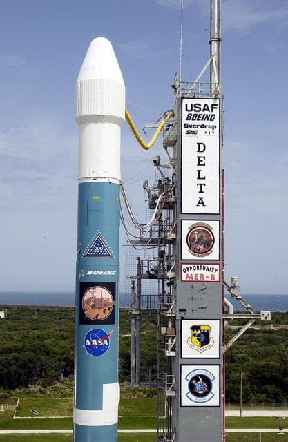 NASA image: KENNEDY SPACE CENTER, FLA. -  The Mobile Service Tower is rolled back at Space Launch Complex 17B, Cape Canaveral Air Force Station, to reveal the Delta II Heavy launch vehicle ready for launch of the Mars Exploration Rover-B (MER-B) mission, with the rover "Opportunity" aboard. The second of twin rovers being sent to Mars, it is equipped with a robotic arm, a drilling tool, three spectrometers, and four pairs of cameras that allow it to have a human-like, 3D view of the terrain. Each rover could travel as far as 100 meters in one day to act as Mars scientists' eyes and hands, exploring an environment where humans are not yet able to go. MER-B is scheduled to launch on June 28 at one of two available times, 11:56:16 p.m. EDT or 12:37:59 a.m. EDT on June 29.