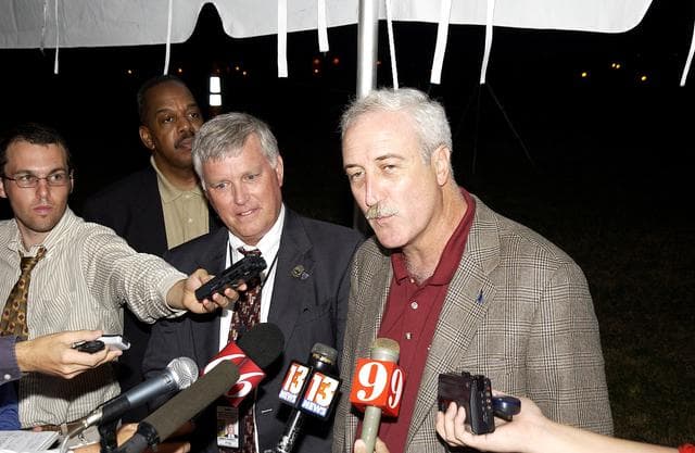 NASA image: KENNEDY SPACE CENTER, FLA. - Newly appointed KSC Director James W. Kennedy (second from left) and NASA Administrator Sean O'Keefe (right) talk to the media following the launch of the Mars Exploration Rover "Opportunity" at the Trident Basin berm press site at Cape Canaveral Air Force Station.