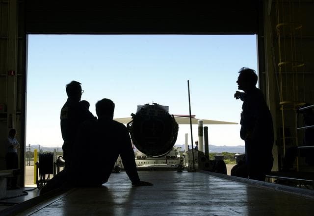 NASA image: KENNEDY SPACE CENTER, FLA. -   Inside the hangar at Vandenberg Air Force Base, Calif., workers wait for the Pegasus launch vehicle to be moved inside.  The Pegasus will carry the SciSat-1 spacecraft in a 400-mile-high polar orbit to investigate processes that control the distribution of ozone in the upper atmosphere.  The scientific mission of SciSat-1 is to measure and understand the chemical processes that control the distribution of ozone in the Earth’s atmosphere, particularly at high altitudes.  The data from the satellite will provide Canadian and international scientists with improved measurements relating to global ozone processes and help policymakers assess existing environmental policy and develop protective measures for improving the health of our atmosphere, preventing further ozone depletion.  The mission is designed to last two years.