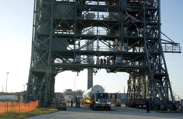 KENNEDY SPACE CENTER, FLA. -   On Launch Complex 17-B, Cape Canaveral Air Force Station, the first stage of a Delta II rocket arrives at the pad.  The rocket is being erected to launch the Space InfraRed Telescope Facility (SIRTF).  Consisting of an 0.85-meter telescope and three cryogenically cooled science instruments, SIRTF is one of NASA's largest infrared telescopes to be launched.  SIRTF will obtain images and spectra by detecting the infrared energy, or heat, radiated by objects in space. Most of this infrared radiation is blocked by the Earth's atmosphere and cannot be observed from the ground.