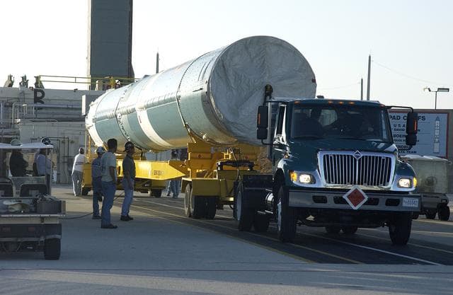NASA image: KENNEDY SPACE CENTER, FLA. -   On Launch Complex 17-B, Cape Canaveral Air Force Station, the first stage of a Delta II rocket waits to be lifted up into the mobile service tower.  The rocket is being erected to launch the Space InfraRed Telescope Facility (SIRTF).  Consisting of an 0.85-meter telescope and three cryogenically cooled science instruments, SIRTF is one of NASA's largest infrared telescopes to be launched.  SIRTF will obtain images and spectra by detecting the infrared energy, or heat, radiated by objects in space. Most of this infrared radiation is blocked by the Earth's atmosphere and cannot be observed from the ground.