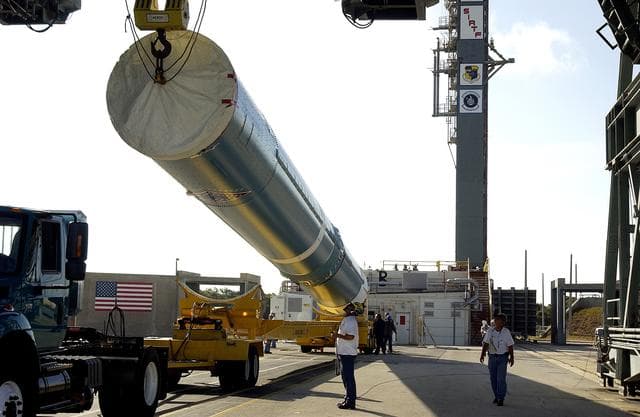 NASA image: KENNEDY SPACE CENTER, FLA. -   On Launch Complex 17-B, Cape Canaveral Air Force Station, the first stage of a Delta II rocket is raised off the transporter before lifting and moving it into the mobile service tower.  The rocket is being erected to launch the Space InfraRed Telescope Facility (SIRTF).  Consisting of an 0.85-meter telescope and three cryogenically cooled science instruments, SIRTF is one of NASA's largest infrared telescopes to be launched.  SIRTF will obtain images and spectra by detecting the infrared energy, or heat, radiated by objects in space. Most of this infrared radiation is blocked by the Earth's atmosphere and cannot be observed from the ground.