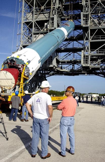 NASA image: KENNEDY SPACE CENTER, FLA. -   On Launch Complex 17-B, Cape Canaveral Air Force Station, the first stage of a Delta II rocket is raised off the transporter before lifting it up and moved into the mobile service tower.  The rocket is being erected to launch the Space InfraRed Telescope Facility (SIRTF).  Consisting of an 0.85-meter telescope and three cryogenically cooled science instruments, SIRTF is one of NASA's largest infrared telescopes to be launched.  SIRTF will obtain images and spectra by detecting the infrared energy, or heat, radiated by objects in space. Most of this infrared radiation is blocked by the Earth's atmosphere and cannot be observed from the ground.