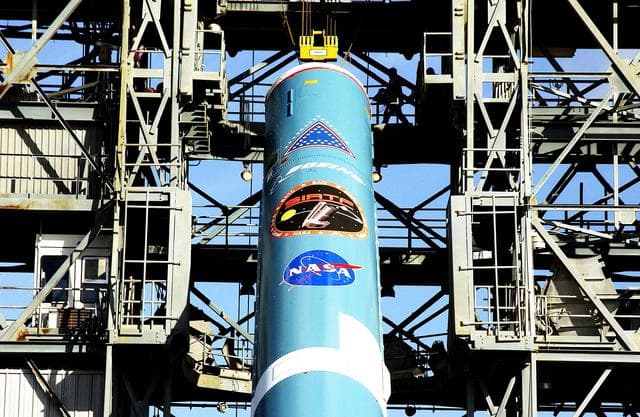 NASA image: KENNEDY SPACE CENTER, FLA. -   On Launch Complex 17-B, Cape Canaveral Air Force Station, the first stage of a Delta II rocket is nearly erect for its move into the mobile service tower.  The rocket is being erected to launch the Space InfraRed Telescope Facility (SIRTF).  Consisting of an 0.85-meter telescope and three cryogenically cooled science instruments, SIRTF is one of NASA's largest infrared telescopes to be launched.  SIRTF will obtain images and spectra by detecting the infrared energy, or heat, radiated by objects in space. Most of this infrared radiation is blocked by the Earth's atmosphere and cannot be observed from the ground.