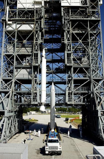 NASA image: KENNEDY SPACE CENTER, FLA. -   Another solid rocket booster (SRB) is lifted to vertical on Launch Complex 17-B, Cape Canaveral Air Force Station, to join the one already in place in the mobile service tower.  The SRBs will be attached to the Delta II Heavy rocket that will launch the Space Infrared Telescope Facility (SIRTF).  The Delta II Heavy features nine 46-inch-diameter, stretched SRBs.  SIRTF, consisting of three cryogenically cooled science instruments and an 0.85-meter telescope, is one of NASA's largest infrared telescopes to be launched.  SIRTF will obtain images and spectra by detecting the infrared energy, or heat, radiated by objects in space. Most of this infrared radiation is blocked by the Earth's atmosphere and cannot be observed from the ground.