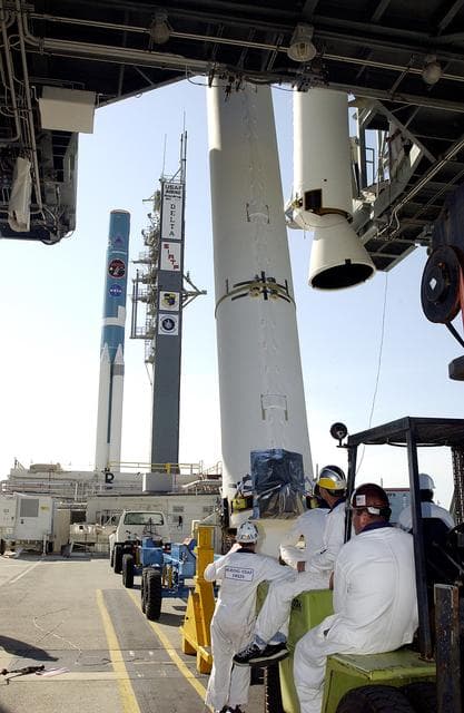 NASA image: KENNEDY SPACE CENTER, FLA. -   Another solid rocket booster (SRB) is lifted to vertical on Launch Complex 17-B, Cape Canaveral Air Force Station, to join the one already in place in the mobile service tower.  The SRBs will be attached to the Delta II Heavy rocket in the background that will launch the Space Infrared Telescope Facility (SIRTF). The Delta II Heavy features nine 46-inch-diameter, stretched SRBs.  SIRTF, consisting of three cryogenically cooled science instruments and an 0.85-meter telescope, is one of NASA's largest infrared telescopes to be launched.  SIRTF will obtain images and spectra by detecting the infrared energy, or heat, radiated by objects in space. Most of this infrared radiation is blocked by the Earth's atmosphere and cannot be observed from the ground.
