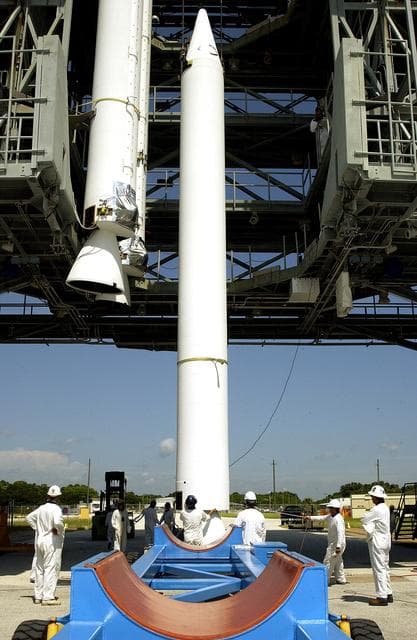NASA image: KENNEDY SPACE CENTER, FLA. -   On Launch Complex 17-B, Cape Canaveral Air Force Station, a solid rocket booster (SRB) is lifted into the mobile service tower, joining two others.  They are three of nine  46-inch-diameter, stretched SRBs that are being attached to the Delta II Heavy rocket that will launch the Space Infrared Telescope Facility (SIRTF).  Consisting of three cryogenically cooled science instruments and an 0.85-meter telescope, SIRTF is one of NASA's largest infrared telescopes to be launched.  SIRTF will obtain images and spectra by detecting the infrared energy, or heat, radiated by objects in space. Most of this infrared radiation is blocked by the Earth's atmosphere and cannot be observed from the ground.