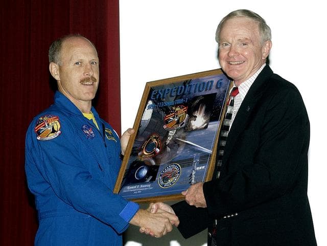 NASA image: KENNEDY SPACE CENTER, FLA. - Expedition 6 Commander Ken Bowersox (left) accepts from Center Director Roy Bridges Jr. a framed graphic commemorating his stay on the International Space Station.  Bowersox spoke to KSC employees about his mission and residence on the Station from November 25, 2002, to May 3, 2003.