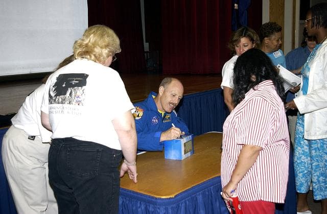 NASA image: KENNEDY SPACE CENTER, FLA. -   Expedition 6 Commander Ken Bowersox happily signs autographs for KSC employees after his presentation about his mission and residence on the International Space Station from November 25, 2002, to May 3, 2003.