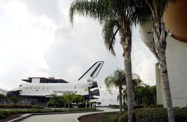 NASA image: KENNEDY SPACE CENTER, FLA.  -  One of the featured displays at the KSC Visitor Complex is the genuine external tank  (center) with twin solid rocket boosters, seen here at the lower end.  The tank and boosters are paired with a full-size replica of a Space Shuttle Orbiter in the Shuttle Plaza.