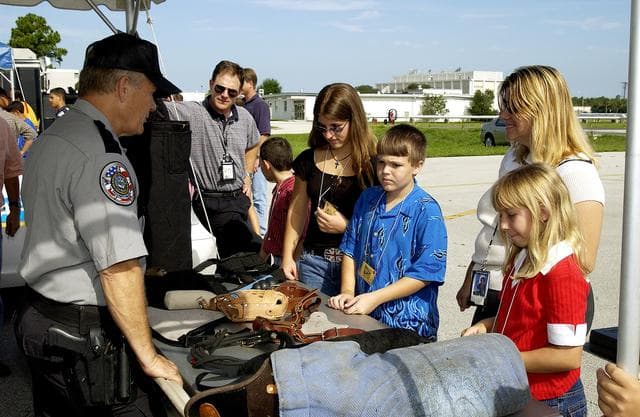 NASA image: KENNEDY SPACE CENTER, FLA.  -  Children enjoy displays of security equipment during Take Our Children to Work Day.  Employees were invited to share their work experience with their children on this annual event.