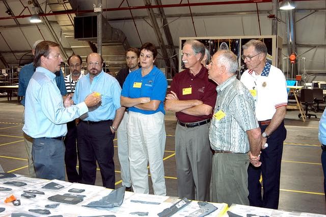 NASA image: KENNEDY SPACE CENTER, FLA.  -  In the Columbia Debris Hangar, Shuttle Launch Director Mike Leinbach (left) talks to members of the  Stafford-Covey Return to Flight Task Group (SCTG) about reconstruction efforts.   Chairing the task group are Richard O. Covey (second from right), former Space Shuttle commander, and Thomas P. Stafford, Apollo commander.  Chartered by NASA Administrator Sean O’Keefe, the task group will perform an independent assessment of NASA’s implementation of the final recommendations by the Columbia Accident Investigation Board.