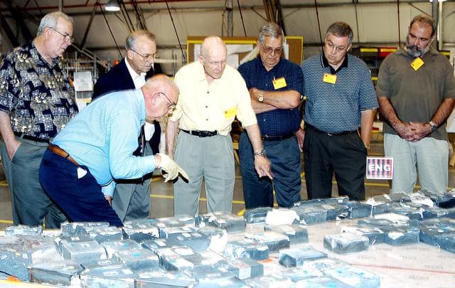 NASA image: KENNEDY SPACE CENTER, FLA.  -  In the Columbia Debris Hangar, members of the  Stafford-Covey Return to Flight Task Group (SCTG) look at tiles recovered.  Chairing the task group are Richard O. Covey, former Space Shuttle commander, and Thomas P. Stafford (center), Apollo commander.  Chartered by NASA Administrator Sean O’Keefe, the task group will perform an independent assessment of NASA’s implementation of the final recommendations by the Columbia Accident Investigation Board.