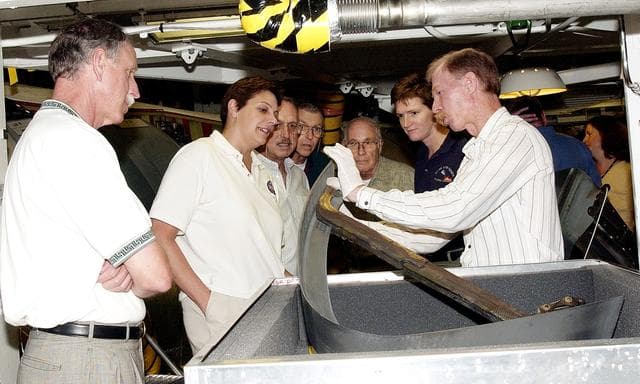 NASA image: KENNEDY SPACE CENTER, FLA.  - On a tour of the Orbiter Processing Facility, members of the Stafford-Covey Return to Flight Task Group (RTFTG) look at a Reinforced Carbon-Carbon panels with a T-seal held by Tom Roberts, with United Space Alliance.  From left are Richard O. Covey, former Space Shuttle commander, Dr. Kathryn Clark, James Adamson, Joe Engle, William Wegner and Dr. Amy Donahue.  Chairing the task group are Covey and Thomas P. Stafford, Apollo commander.  Chartered by NASA Administrator Sean O’Keefe, the task group will perform an independent assessment of NASA’s implementation of the final recommendations by the Columbia Accident Investigation Board.