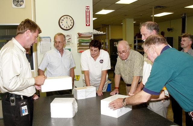 NASA image: KENNEDY SPACE CENTER, FLA.  -  On a tour of the Tile Shop, members of the Stafford-Covey Return to Flight Task Group (SCTG) learn about PU-tiles, part of an orbiter’s Thermal Protection System.   At left is Martin Wilson, with United Space Alliance.  Others (left to right) around the table are James Adamson, Dr. Kathryn Clark, William Wegner, Richard Covey and Joe Engle.  Covey, former Space Shuttle commander, is co-chair of the  SCTG, along with Thomas P. Stafford, Apollo commander.  Chartered by NASA Administrator Sean O’Keefe, the task group will perform an independent assessment of NASA’s implementation of the final recommendations by the Columbia Accident Investigation Board.