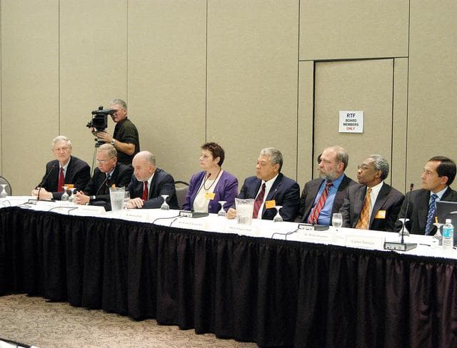 NASA image: KENNEDY SPACE CENTER, FLA.  -  The Return To Flight Task Group (RTFTG) holds the first public meeting at the Debus Center, KSC Visitor Complex.  Members and staff at the table, from left, are retired Navy Rear Adm. Walter H. Cantrell, David Raspet, retired Air Force Col. Gary S. Geyer, Dr. Kathryn Clark, Dr. Decatur B. Rogers, Dr. Dan L. Crippen, Dr. Walter Broadnax and astronaut Carlos Noriega.  The RTFTG was at KSC to conduct organizational activities, tour Space Shuttle facilities and receive briefings on Shuttle-related topics.  The task group was chartered by NASA Administrator Sean O’Keefe to perform an independent assessment of NASA’s implementation of the final recommendations of the Columbia Accident Investigation Board.  The group is co-chaired by former Shuttle commander Richard O. Covey and retired Air Force Lt. Gen. Thomas P. Stafford, who was an Apollo commander.