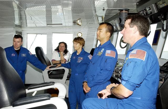 NASA image: KENNEDY SPACE CENTER, FLA. -  The STS-114 crew visit the bridge of the Liberty Star, one of two SRB Retrieval Ships.  From left are Pilot James Kelly, Louise Kleba (with the Vehicle Integration Test Team (VITT) office), Commander Eileen Collins and Mission Specialists Soichi Noguchi and Stephen Robinson. Noguchi is with the Japanese space agency NASDA. On their mission, the crew will carry the MultiPurpose Logistics Module (MPLM) Raffaello and External Stowage Platform 2 to the International Space Station.  The MPLM will contain supplies and equipment.  Another goal of the mission is to remove and replace a Control Moment Gyro.  Launch date for mission STS-114 is under review.