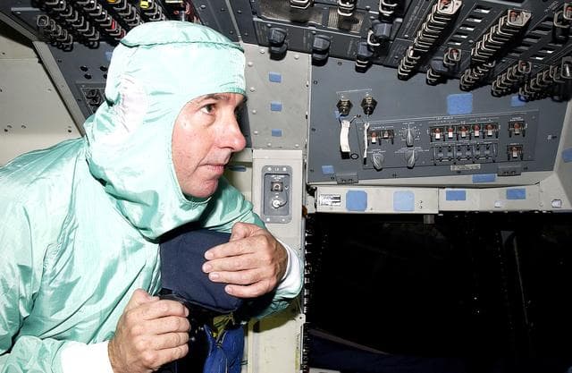 NASA image: KENNEDY SPACE CENTER, FLA. -   STS-114 Mission Specialist Stephen Robinson looks at equipment in the flight deck of orbiter Atlantis.  He and other crew members -  Commander Eileen Collins, Pilot James Kelly and Mission Specialist Soichi Noguchi - are at KSC for equipment familiarization.  Noguchi is with the Japanese space agency NASDA.  Mission STS-114 will carry the MultiPurpose Logistics Module (MPLM) Raffaello and External Stowage Platform 2 to the International Space Station.  The MPLM will contain supplies and equipment.  Another goal of the mission is to remove and replace a Control Moment Gyro.  Launch date for mission STS-114 is under review.