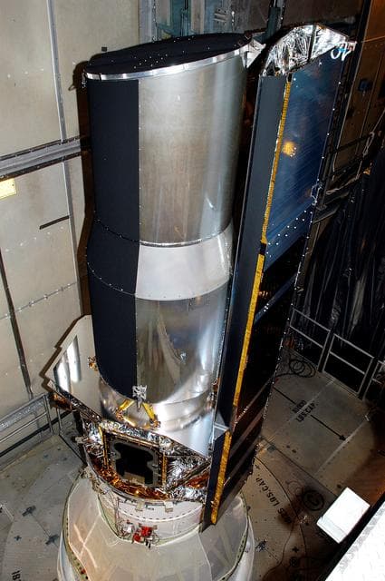 NASA image: KENNEDY SPACE CENTER, FLA.  - In the mobile service tower on Launch Pad 17-B, Cape Canaveral Air Force Station, the Space Infrared Telescope Facility (SIRTF) waits for encapsulation. SIRTF will obtain images and spectra by detecting the infrared energy, or heat, radiated by objects in space. Consisting of a 0.85-meter telescope and three cryogenically cooled science instruments, SIRTF will be the largest infrared telescope ever launched into space. It is the fourth and final element in NASA’s family of orbiting “Great Observatories.” Its highly sensitive instruments will give a unique view of the Universe and peer into regions of space that are hidden from optical telescopes.