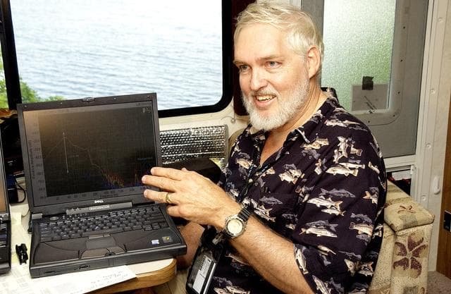 NASA image: KENNEDY SPACE CENTER, FLA.  -  Dr. Grant Gilmore, Dynamac Corp., utilizes a laptop computer to explain aspects of the underwater acoustic research under way in the Launch Complex 39 turn basin.  Several government agencies, including NASA, NOAA, the Navy, the Coast Guard, and the Florida Fish and Wildlife Commission are involved in the testing. The research involves demonstrations of passive and active sensor technologies, with applications in fields ranging from marine biological research to homeland security. The work is also serving as a pilot project to assess the cooperation between the agencies involved. Equipment under development includes a passive acoustic monitor developed by NASA’s Jet Propulsion Laboratory, and mobile robotic sensors from the Navy’s Mobile Diving and Salvage Unit.