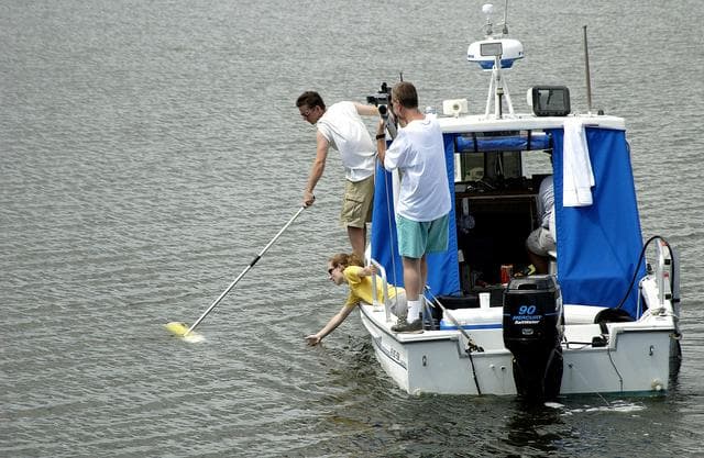 NASA image: KENNEDY SPACE CENTER, FLA.  -  Research team members aboard one of the watercraft being utilized to conduct underwater acoustic research in the Launch Complex 39 turn basin retrieve some of the project's equipment from the water.  Several government agencies, including NASA, NOAA, the Navy, the Coast Guard, and the Florida Fish and Wildlife Commission are involved in the testing. The research involves demonstrations of passive and active sensor technologies, with applications in fields ranging from marine biological research to homeland security. The work is also serving as a pilot project to assess the cooperation between the agencies involved. Equipment under development includes a passive acoustic monitor developed by NASA’s Jet Propulsion Laboratory, and mobile robotic sensors from the Navy’s Mobile Diving and Salvage Unit.
