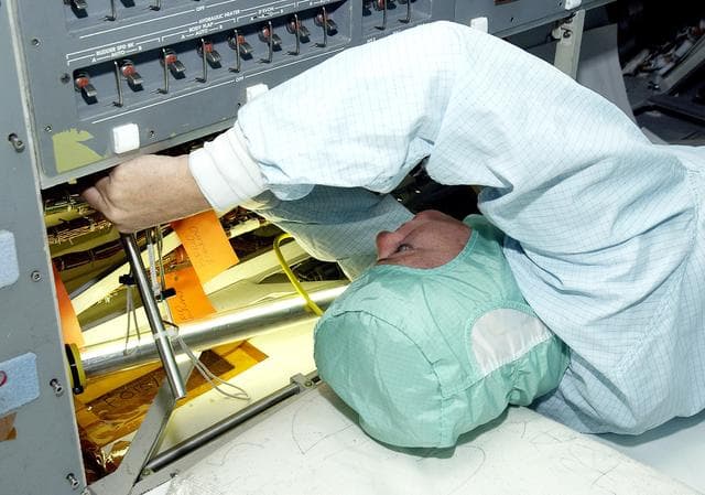 NASA image: KENNEDY SPACE CENTER, FLA.  -     A technician with United Space Alliance checks wiring in the mid-body and flight deck of  orbiter Atlantis as part of routine maintenance.