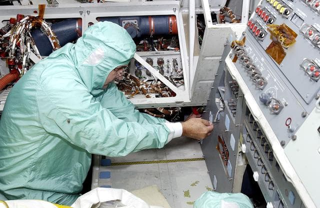 NASA image: KENNEDY SPACE CENTER, FLA.  -    A technician with United Space Alliance checks wiring in the mid-body of  orbiter Atlantis as part of routine maintenance.