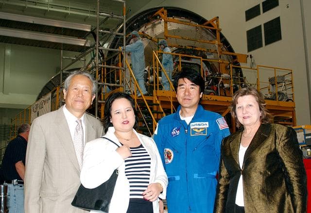 NASA image: KENNEDY SPACE CENTER, FLA. - From left, the Consul General of Japan Ko Kodaira, his daughter Reiko, astronaut Dr. Takao Doi, and Kodaira's wife Marie pause for a photograph in the Space Station Processing Facility during their visit to Kennedy Space Center (KSC). Doi represented Japan on Space Shuttle mission STS-87, the fourth U.S Microgravity Payload flight.  Kodaira is touring the facilities at KSC at the invitation of the local office of the National Space Development Agency of Japan (NASDA) to acquaint him with KSC's unique processing capabilities.