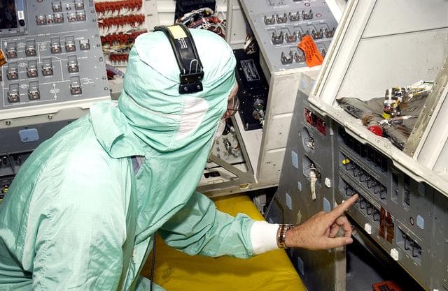 NASA image: KENNEDY SPACE CENTER, FLA.  -  During power-up of the orbiter Discovery in the Orbiter Processing Facility, a technician moves a switch.  Discovery has been undergoing Orbiter Major Modifications in the past year, ranging from wiring, control panels and black boxes to gaseous and fluid systems tubing and components.  These systems were deserviced, disassembled, inspected, modified, reassembled, checked out and reserviced, as were most other systems onboard.  The work includes the installation of the Multifunction Electronic Display Subsystem (MEDS) - a state-of-the-art “glass cockpit.”