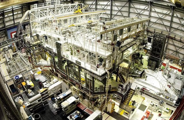 NASA image: KENNEDY SPACE CENTER, FLA. - This bird's-eye view of a high bay in the Orbiter Processing Facility (OPF) shows Space Shuttle Atlantis surrounded by the standard platforms and equipment required to process a Space Shuttle orbiter for flight.  The high bay is 197 feet (60 meters) long, 150 feet (46 meters) wide, 95 feet (29 meters) high, and encompasses a 29,000-square-foot (2,694-meter) area.  Platforms, a main access bridge, and two rolling bridges with trucks provide access to various parts of the orbiter. The next mission scheduled for Atlantis is STS-114, a utilization and logistics flight to the International Space Station.