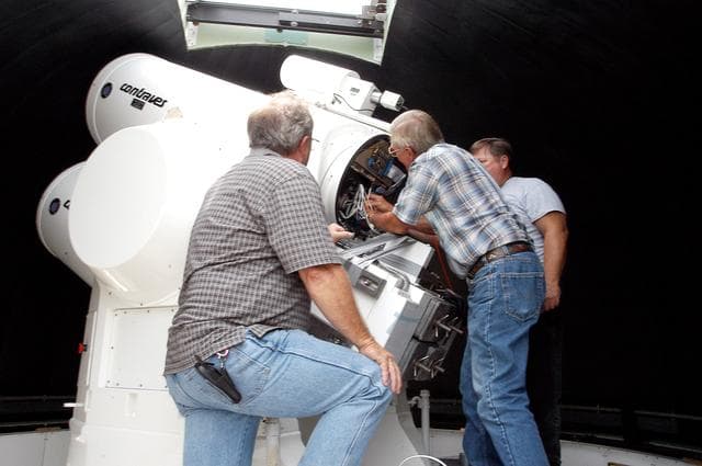 NASA image: KENNEDY SPACE CENTER, FLA. -  Workers calibrate a tracking telescope, part of the Distant Object Attitude Measurement System (DOAMS),  located in Cocoa Beach, Fla.  The telescope provides optical support for launches from KSC and Cape Canaveral.