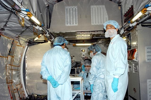 NASA image: KENNEDY SPACE CENTER, FLA. -   Astronaut Soichi Noguchi (right), with the National Space Development Agency of Japan (NASDA), is inside the Japanese Experiment Module (JEM), undergoing a Multi-Element Integrated Test (MEIT)  in the Space Station Processing Facility.  Noguchi is assigned to mission STS-114 as a mission specialist.   Node 2 attaches to the end of the U.S. Lab on the ISS and provides attach locations for the Japanese laboratory, European laboratory, the Centrifuge Accommodation Module and, eventually, Multipurpose Logistics Modules. It will provide the primary docking location for the Shuttle when a pressurized mating adapter is attached to Node 2.  Installation of the module will complete the U.S. Core of the ISS.   The JEM, developed by NASDA,  is Japan's primary contribution to the Station. It will enhance the unique research capabilities of the orbiting complex by providing an additional environment for astronauts to conduct science experiments.