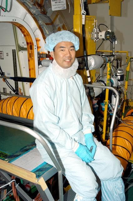 NASA image: KENNEDY SPACE CENTER, FLA. -  Astronaut Soichi Noguchi, with the National Space Development Agency of Japan (NASDA), rests inside the Japanese Experiment Module (JEM), undergoing a Multi-Element Integrated Test (MEIT)  in the Space Station Processing Facility.  Noguchi is assigned to mission STS-114 as a mission specialist.   Node 2 attaches to the end of the U.S. Lab on the ISS and provides attach locations for the Japanese laboratory, European laboratory, the Centrifuge Accommodation Module and, eventually, Multipurpose Logistics Modules. It will provide the primary docking location for the Shuttle when a pressurized mating adapter is attached to Node 2.  Installation of the module will complete the U.S. Core of the ISS.   The JEM, developed by NASDA,  is Japan's primary contribution to the Station. It will enhance the unique research capabilities of the orbiting complex by providing an additional environment for astronauts to conduct science experiments.