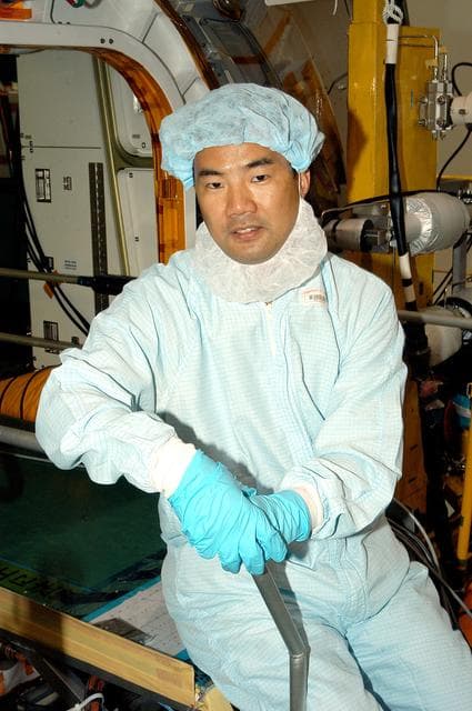 NASA image: KENNEDY SPACE CENTER, FLA. -  Astronaut Soichi Noguchi, with the National Space Development Agency of Japan (NASDA), rests inside the Japanese Experiment Module (JEM), undergoing a Multi-Element Integrated Test (MEIT)  in the Space Station Processing Facility.  Noguchi is assigned to mission STS-114 as a mission specialist.   Node 2 attaches to the end of the U.S. Lab on the ISS and provides attach locations for the Japanese laboratory, European laboratory, the Centrifuge Accommodation Module and, eventually, Multipurpose Logistics Modules. It will provide the primary docking location for the Shuttle when a pressurized mating adapter is attached to Node 2.  Installation of the module will complete the U.S. Core of the ISS.   The JEM, developed by NASDA,  is Japan's primary contribution to the Station. It will enhance the unique research capabilities of the orbiting complex by providing an additional environment for astronauts to conduct science experiments.