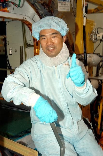 NASA image: KENNEDY SPACE CENTER, FLA. -  Astronaut Soichi Noguchi, with the National Space Development Agency of Japan (NASDA), signals success during a Multi-Element Integrated Test (MEIT ) of the Japanese Experiment Module (JEM) in the Space Station Processing Facility.  Noguchi is assigned to mission STS-114 as a mission specialist.   Node 2 attaches to the end of the U.S. Lab on the ISS and provides attach locations for the Japanese laboratory, European laboratory, the Centrifuge Accommodation Module and, eventually, Multipurpose Logistics Modules. It will provide the primary docking location for the Shuttle when a pressurized mating adapter is attached to Node 2.  Installation of the module will complete the U.S. Core of the ISS.   The JEM, developed by NASDA,  is Japan's primary contribution to the Station. It will enhance the unique research capabilities of the orbiting complex by providing an additional environment for astronauts to conduct science experiments.