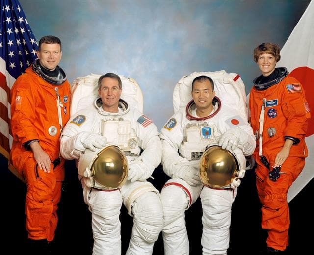 NASA image: JOHNSON SPACE CENTER, HOUSTON, TEXAS -- (STS114-S-002) -- These four astronauts are in training for the STS-114 mission. Astronauts Eileen M. Collins, mission commander, and James M. Kelly, pilot, flank the two mission specialists -- astronauts Stephen K. Robinson (second from left) and Soichi Noguchi -- who are assigned to spacewalk duty to perform work on the International Space Station. Noguchi represents the Japanese Space agency.