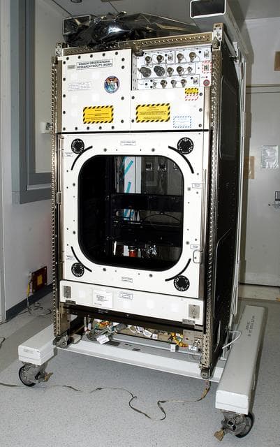 NASA image: KENNEDY SPACE CENTER, FLA. -  The Window Observational Research Facility (WORF), seen in the Space Station Processing Facility, was designed and built by the Boeing Co. at NASA’s Marshall Space Flight Center in Huntsville, Ala.   WORF will be delivered to the International Space Station and placed in the rack position in front of the Destiny lab window,  providing locations for attaching cameras, multi-spectral scanners and other instruments. WORF will support a variety of scientific and commercial experiments in areas of Earth systems and processes, global ecological changes in Earth’s biosphere, lithosphere, hydrosphere and climate system, Earth resources, natural hazards, and education.  After installation, it will become a permanent focal point for Earth Science research aboard the space station.