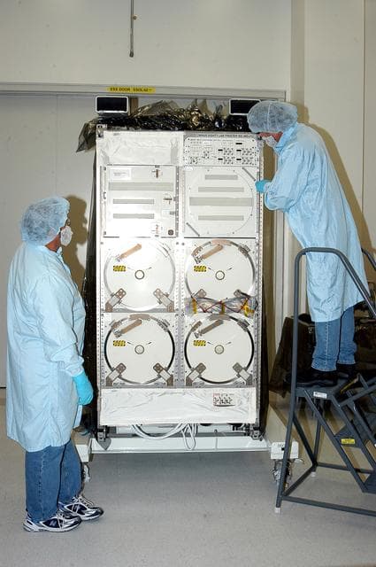 NASA image: KENNEDY SPACE CENTER, FLA. -  After removing its cover, technicians look over the Minus Eighty Lab Freezer for ISS (MELFI),  provided as Laboratory Support Equipment by the European Space Agency for the International Space Station.  The lab will provide cooling and storage for reagents, samples and perishable materials in four insulated containers called dewars with independently selectable temperatures of -80°C, -26°C, and +4°C. It also will be used to transport samples to and from the station.   The MELFI is planned for launch on the ULF-1 mission.
