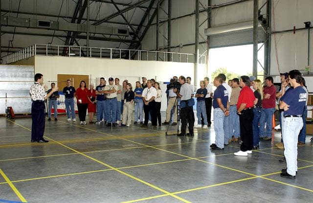 NASA image: KENNEDY SPACE CENTER, FLA. -  Scott Thurston, NASA vehicle flow manager, speaks to members of the Columbia Reconstruction Team during transfer of debris from the Columbia Debris Hangar to its permanent storage site in the Vehicle Assembly Building.  More than 83,000 pieces of debris were shipped to KSC during search and recovery efforts in East Texas. That represents about 38 percent of the dry weight of Columbia, equaling almost 85,000 pounds.