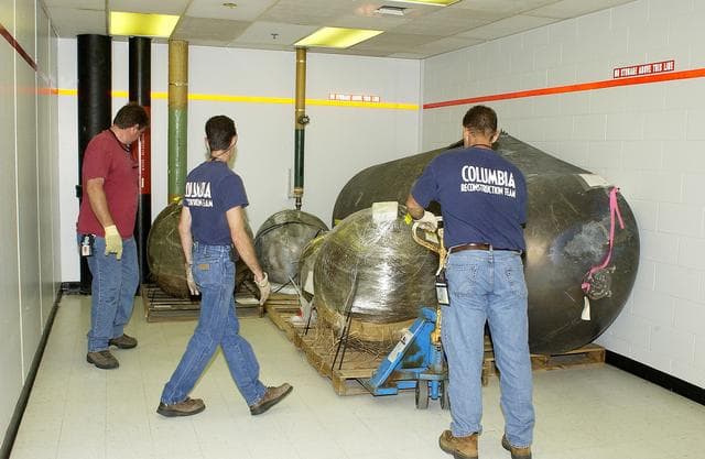 NASA image: KENNEDY SPACE CENTER, FLA.  -   Workers place some of the Columbia debris moved from the Columbia Debris Hangar in its permanent storage site in the Vehicle Assembly Building.  More than 83,000  pieces of debris were shipped to KSC during search and recovery efforts in East Texas. That represents about 38 percent of the dry weight of Columbia, equaling almost 85,000 pounds.