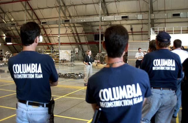 NASA image: KENNEDY SPACE CENTER, FLA. -  Astronaut Pam Melroy speaks to members of the Columbia Reconstruction Team during transfer of debris from the Columbia Debris Hangar to its permanent storage site in the Vehicle Assembly Building.  More than 83,000 pieces of debris were shipped to KSC during search and recovery efforts in East Texas. That represents about 38 percent of the dry weight of Columbia, equaling almost 85,000 pounds.